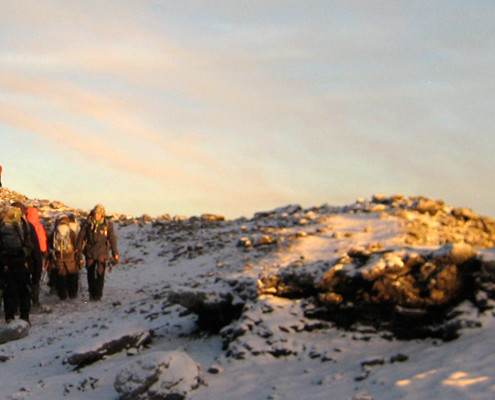 trekkers using trekking poles on the kilimanjaro summit